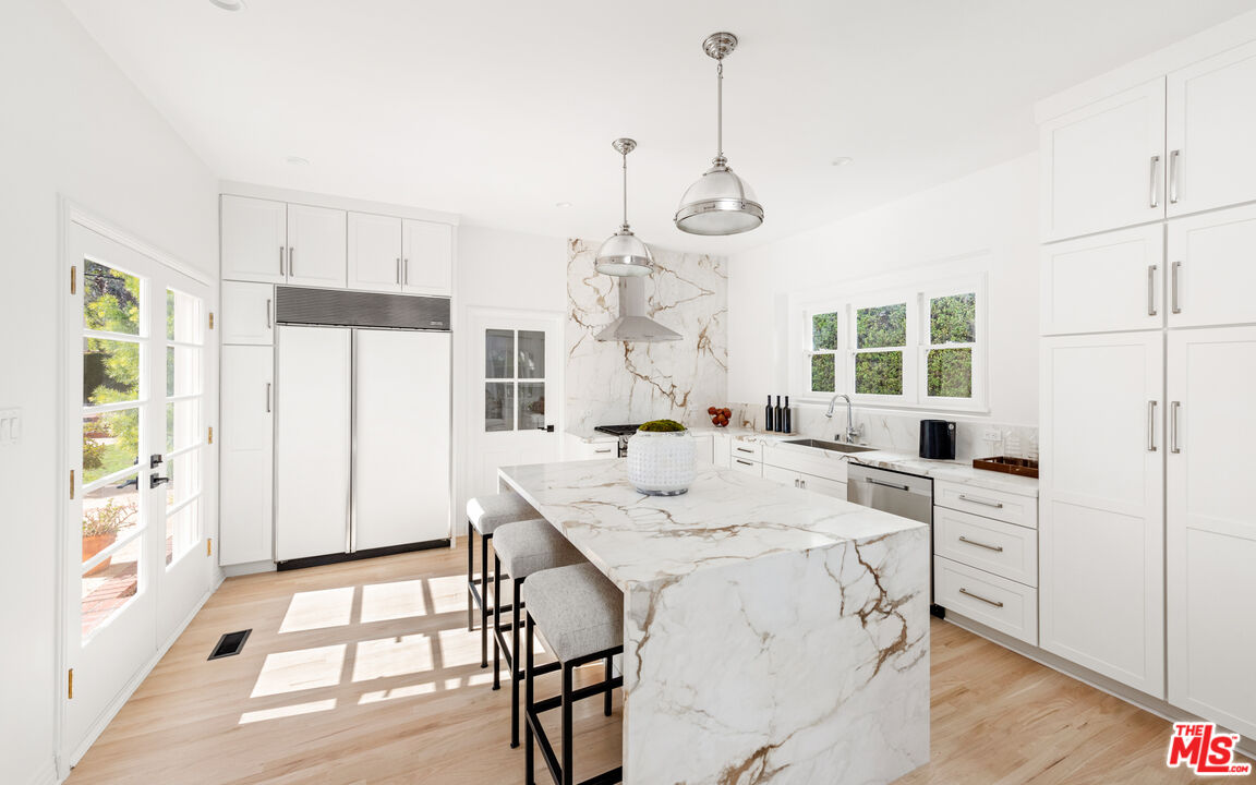 625 Sierra Drive Beverly Hills, CA 90210 - Photo 4 of 25 a view of a kitchen with a table and chairs