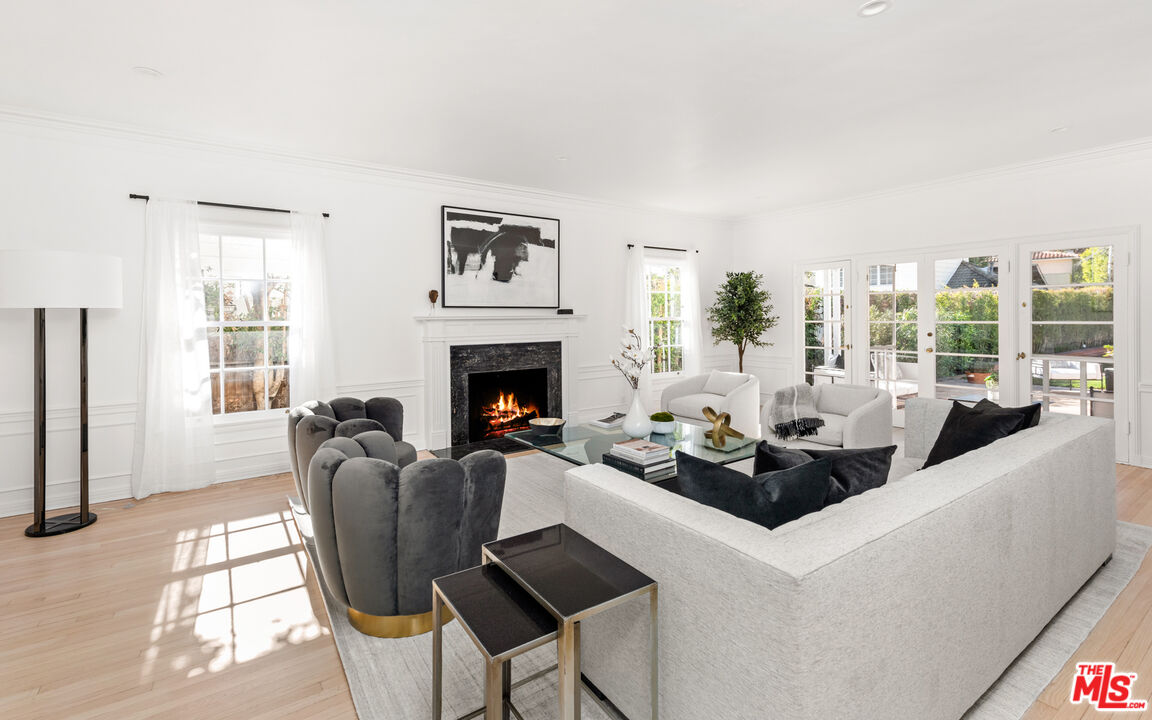 625 Sierra Drive Beverly Hills, CA 90210 - Photo 7 of 25 a living room with furniture fireplace and large windows