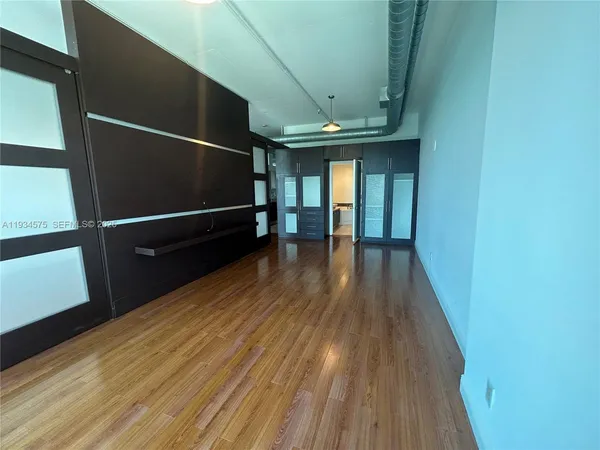 a view of a room with wooden floor