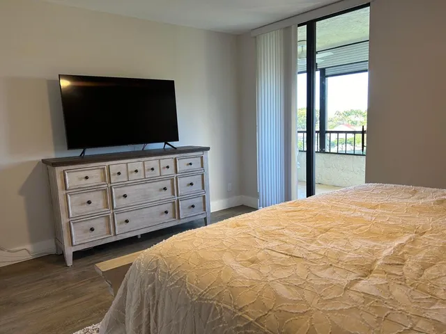 a bedroom with a bed and a flat screen tv