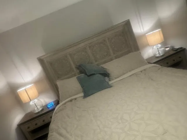a bedroom with a bed and a lamp