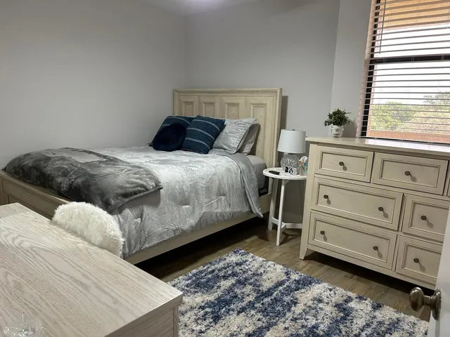 a bedroom with a bed and a window