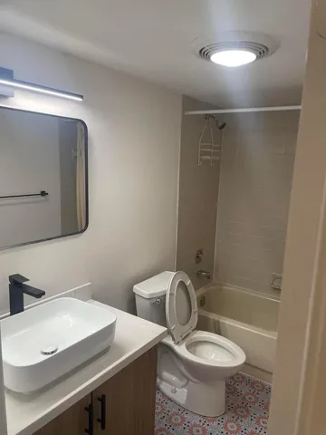 a bathroom with a sink toilet and mirror