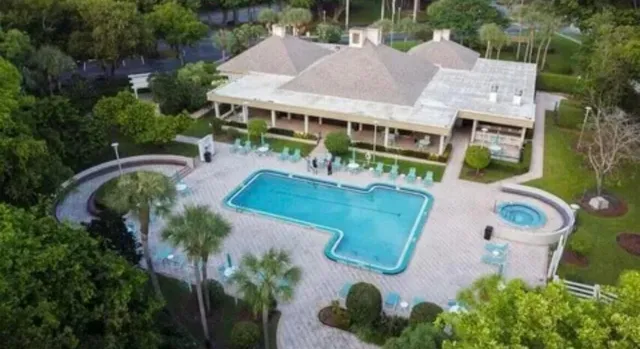 an aerial view of a house with garden space and sitting area