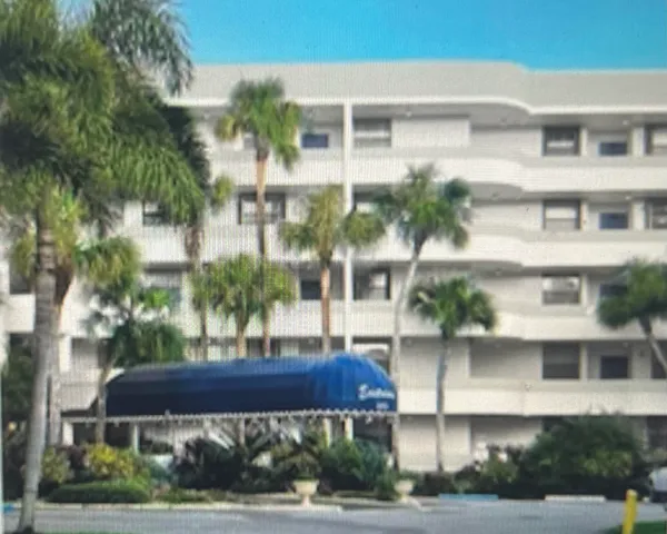 a view of house with a yard and potted plants