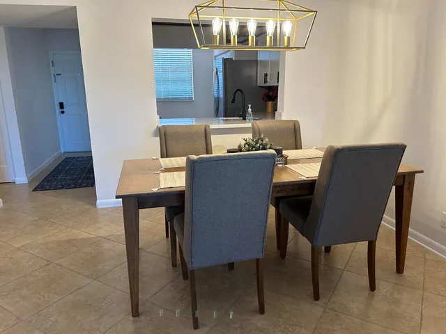 a dining room with furniture and chandelier fan
