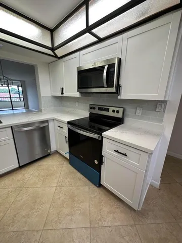 a kitchen with a stove and a microwave