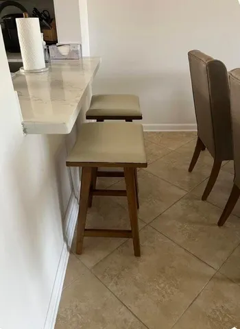 a balcony with table and chairs