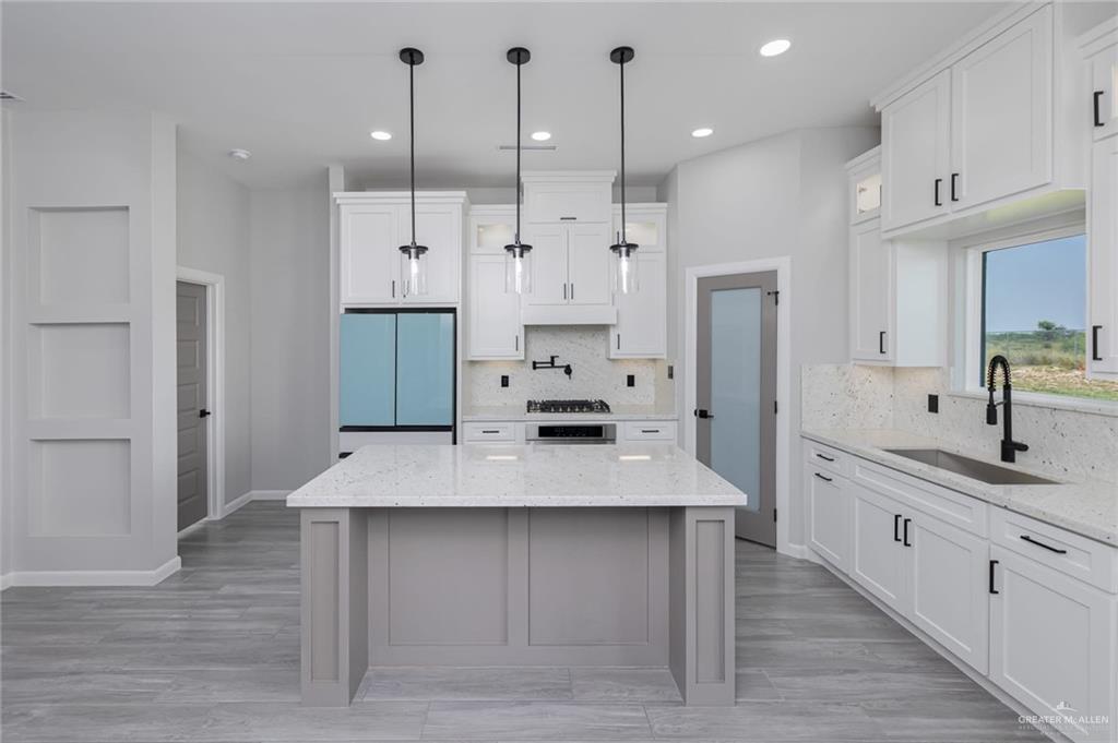 7710 Navel Lane Mission, TX 78574 - Photo 6 of 20 a large kitchen with kitchen island a sink stainless steel appliances and cabinets
