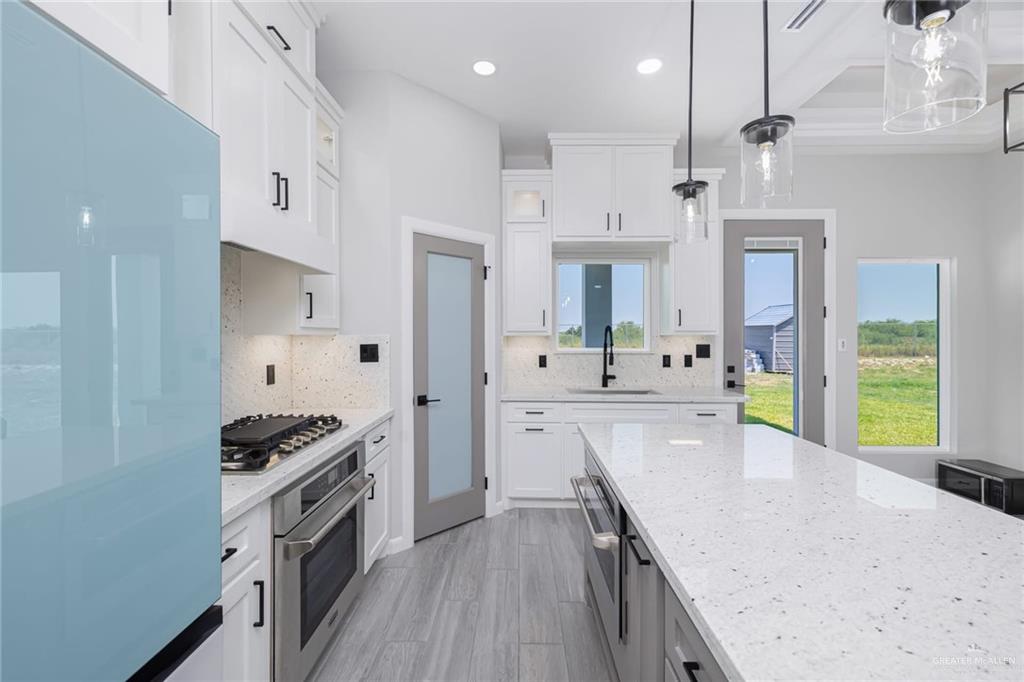 7710 Navel Lane Mission, TX 78574 - Photo 8 of 20 a kitchen with granite countertop a sink stainless steel appliances and cabinets