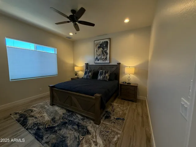 a bedroom with a bed and wooden floor