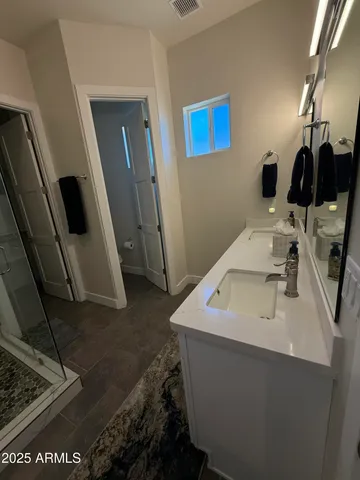 a bathroom with a sink a toilet and mirror