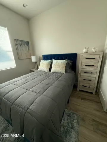 a bedroom with a bed and a lamp