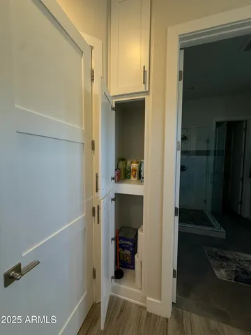 a view of a hallway with entryway and furniture