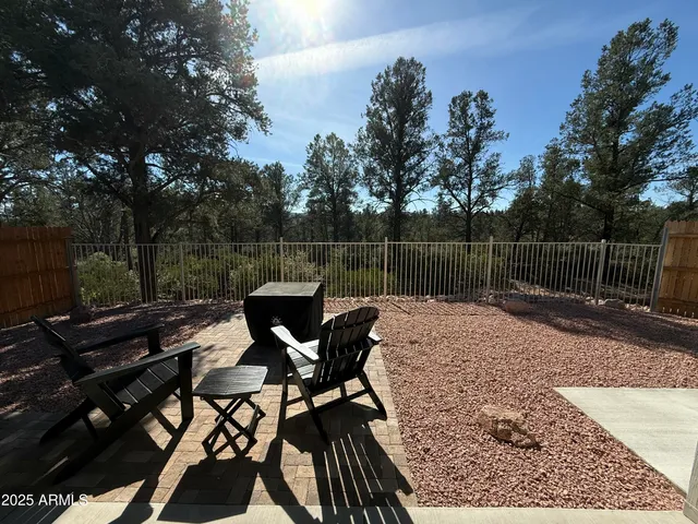 a view of a roof deck with table and chairs and wooden floor
