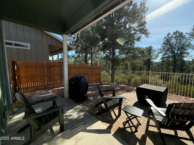 a view of a chairs and a table in the balcony