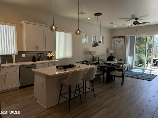 a kitchen with a sink stove and wooden floor