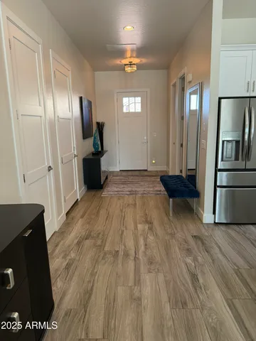 a kitchen with stainless steel appliances a refrigerator and wooden floor