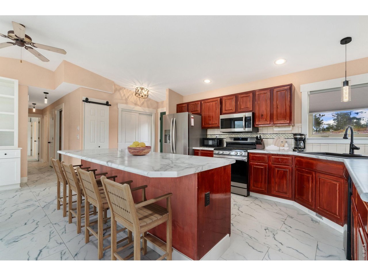 141 Tami Road Red Feather Lakes, CO 80545 - Photo 5 of 43 Open concept kitchen with large breakfast bar island (virtually staged).