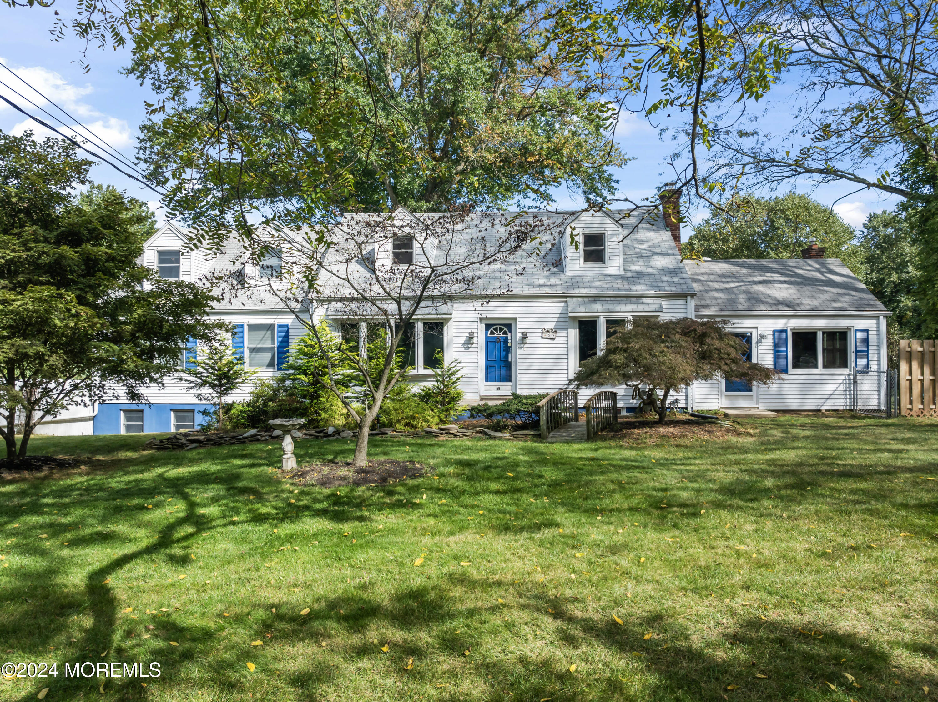 55 Swimming River Road Lincroft, NJ 07738 - Photo 1 of 51 a front view of a house with a garden