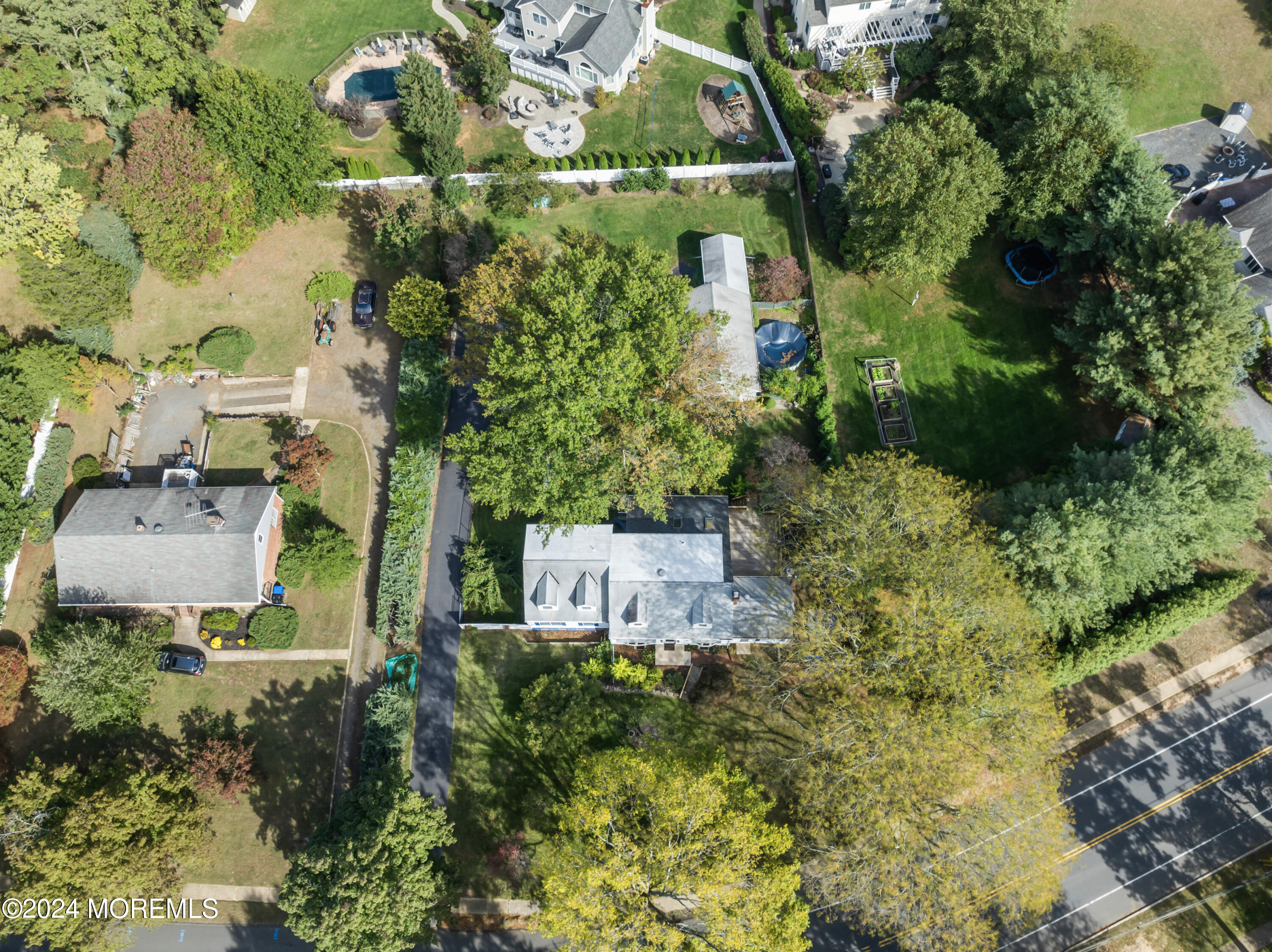 55 Swimming River Road Lincroft, NJ 07738 - Photo 2 of 51 an aerial view of a house with a yard and garden