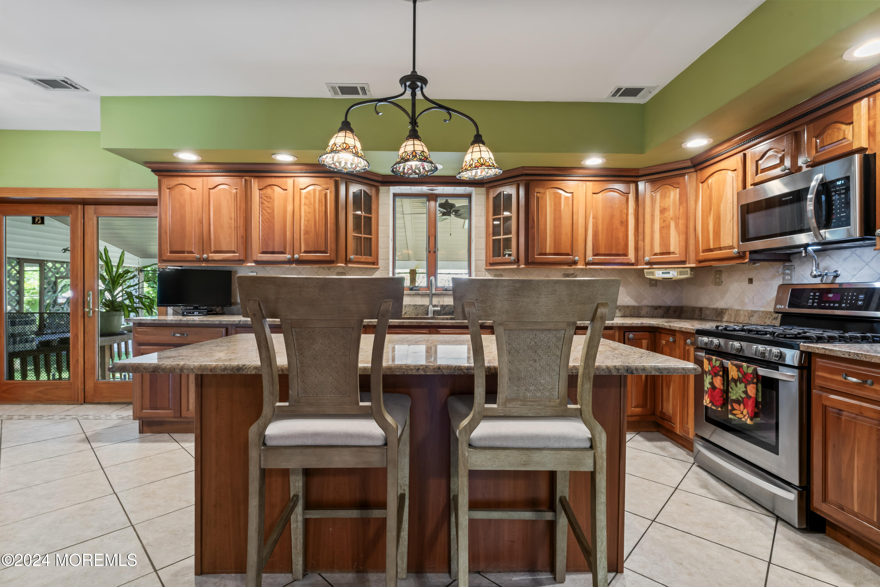 55 Swimming River Road Lincroft, NJ 07738 - Photo 6 of 51 a kitchen with stainless steel appliances granite countertop a stove a sink and a microwave