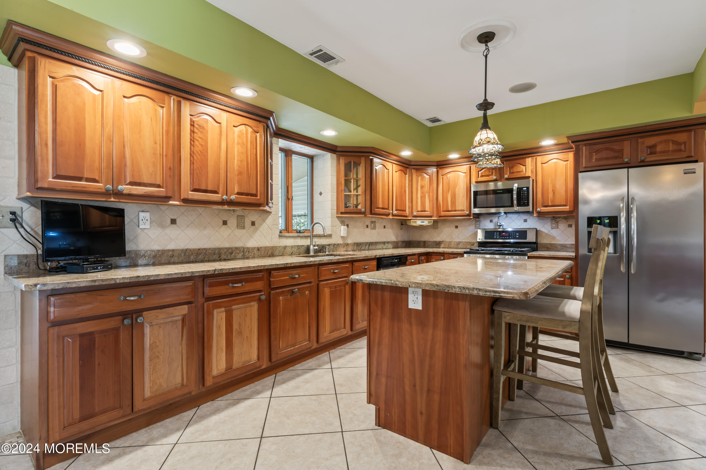 55 Swimming River Road Lincroft, NJ 07738 - Photo 8 of 51 a kitchen with stainless steel appliances granite countertop wooden cabinets a sink and a window