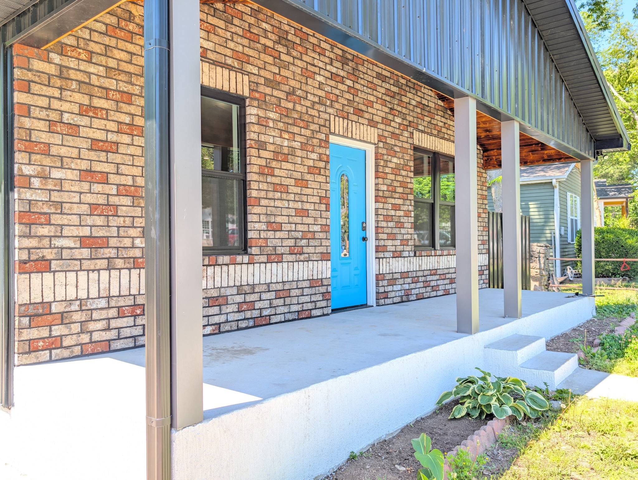 244 Warrior Road Madison, TN 37115 - Photo 2 of 24 a view of a porch with a floor to ceiling window and wooden fence