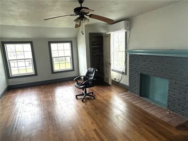 a view of a livingroom with a fireplace and window