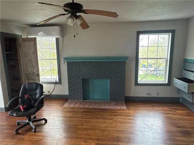 a view of a livingroom with workspace and a window