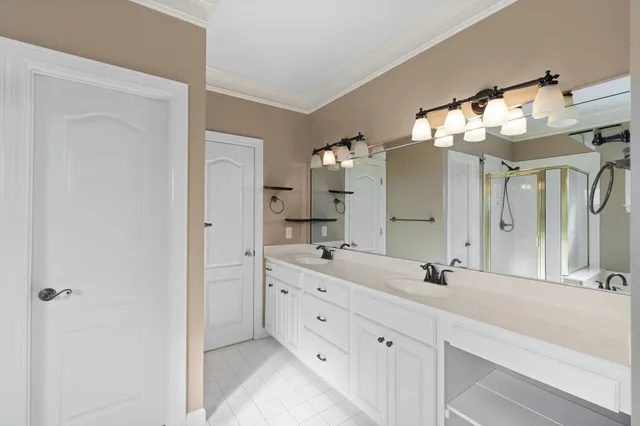 a bathroom with a double vanity sink and a mirror