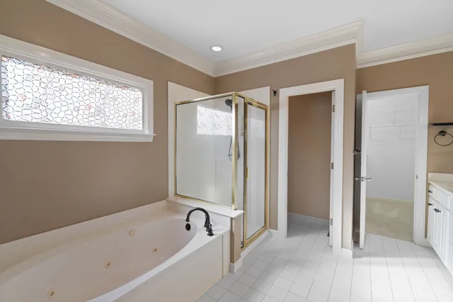 a bathroom with a tub a sink and a shower