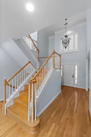 a view of staircase with white walls and wooden floor