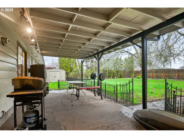 a view of a porch with furniture and garden