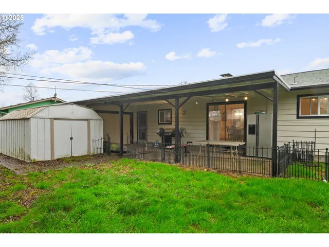 a view of a house with a yard and sitting area