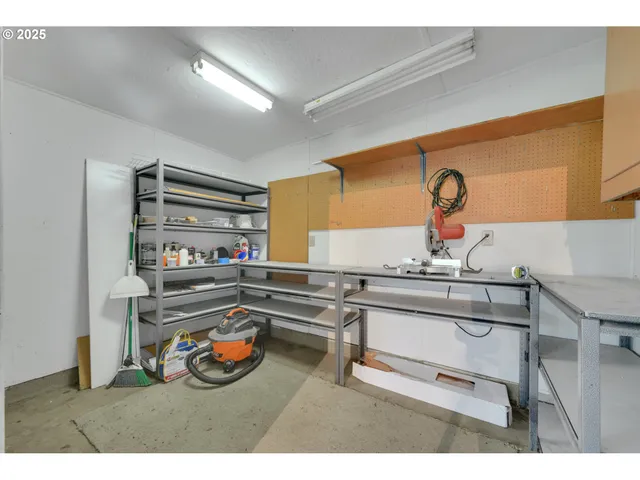 a kitchen with a sink and a stove with chairs
