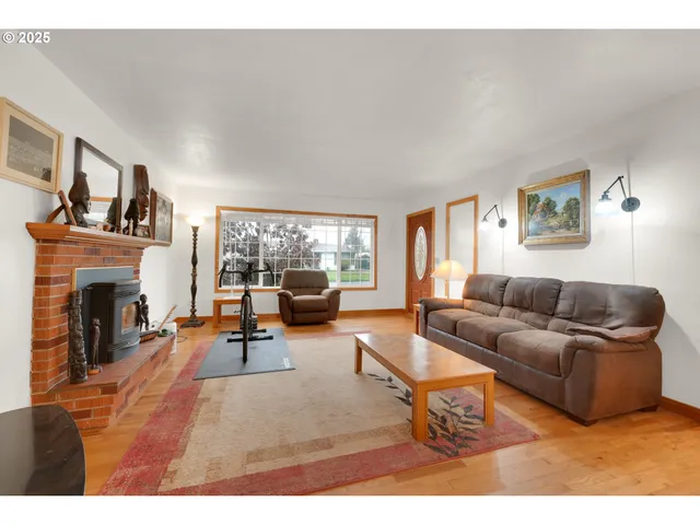a living room with furniture a fireplace and a large window