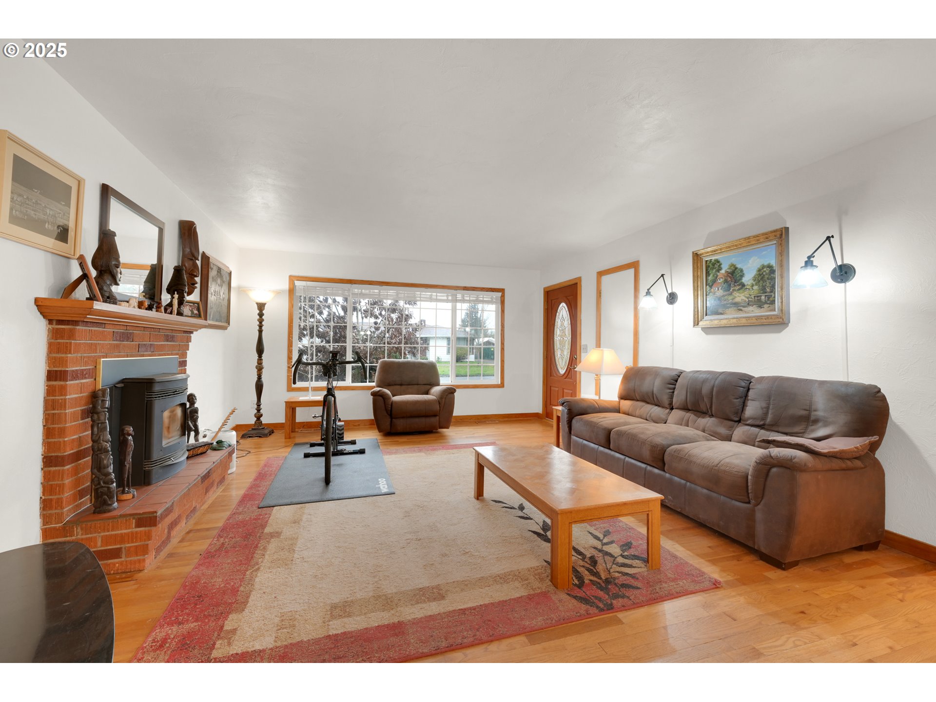 2617 Southeast Fulton Street Albany, OR 97322 - Photo 5 of 35 a living room with furniture a fireplace and a large window