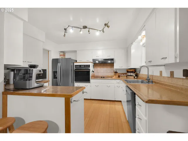 a kitchen with refrigerator and stove