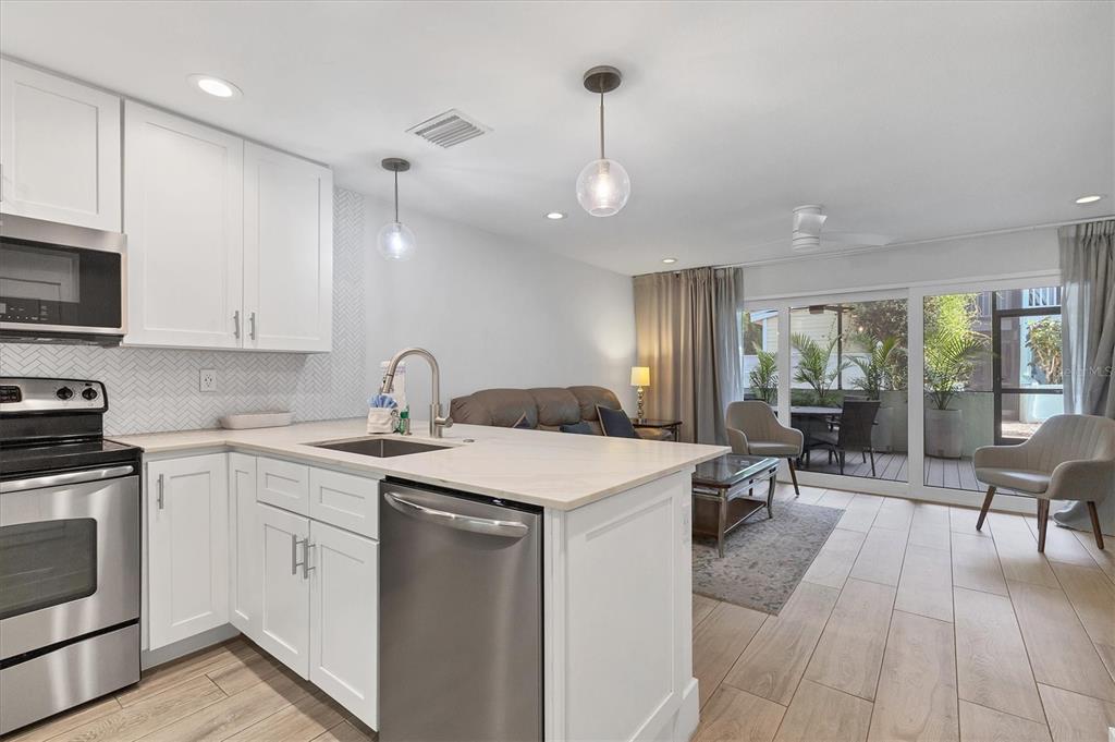 1762 Stickney Point Road, Unit 204 Sarasota, FL 34231 - Photo 13 of 38 a kitchen with a sink stainless steel appliances and cabinets