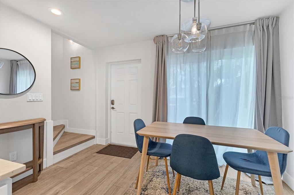 1762 Stickney Point Road, Unit 204 Sarasota, FL 34231 - Photo 15 of 38 a view of a dining room with furniture and wooden floor