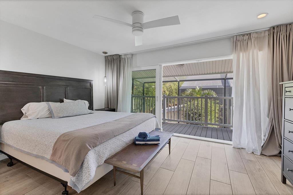 1762 Stickney Point Road, Unit 204 Sarasota, FL 34231 - Photo 19 of 38 a bedroom with a large bed and a large window