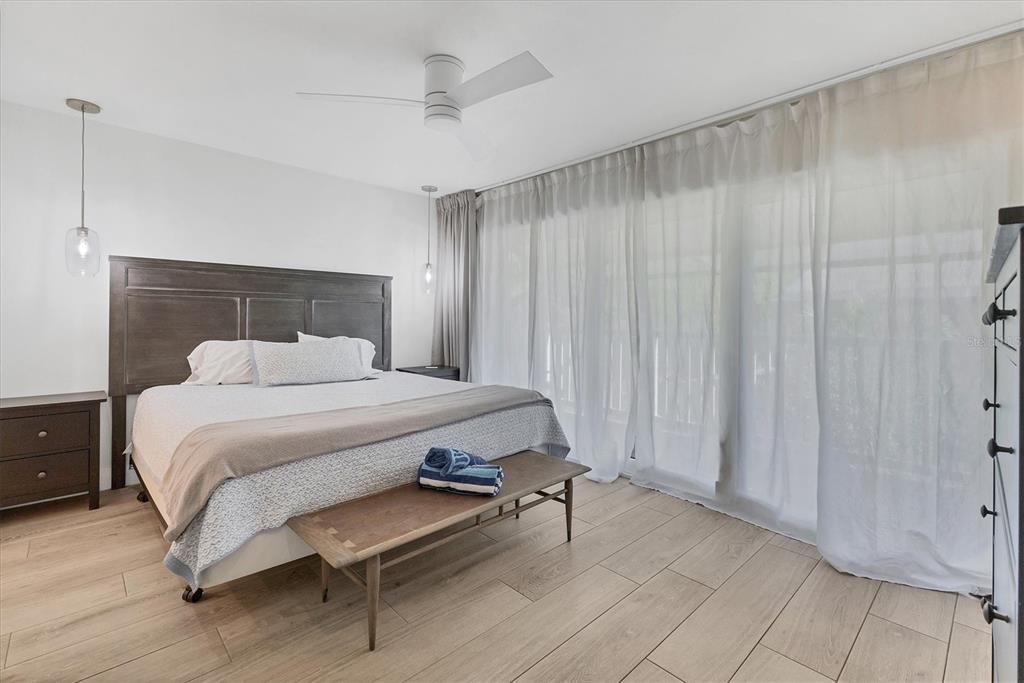 1762 Stickney Point Road, Unit 204 Sarasota, FL 34231 - Photo 20 of 38 a bedroom with a bed and a table in it