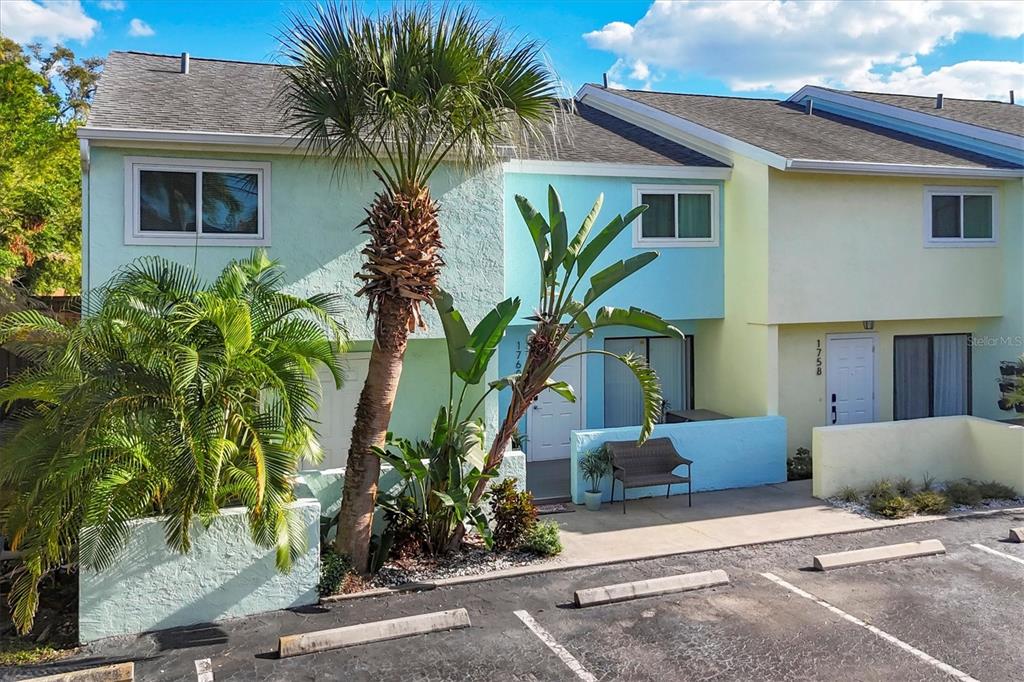 1762 Stickney Point Road, Unit 204 Sarasota, FL 34231 - Photo 2 of 38 a plant is in front of a house