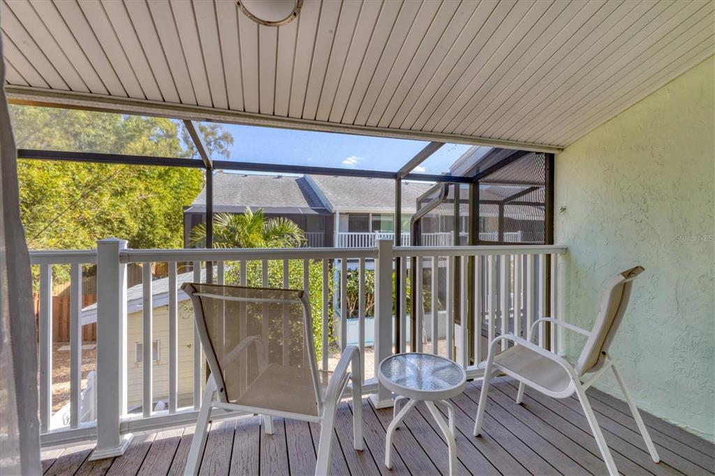 1762 Stickney Point Road, Unit 204 Sarasota, FL 34231 - Photo 22 of 38 a view of a chairs and table in the balcony