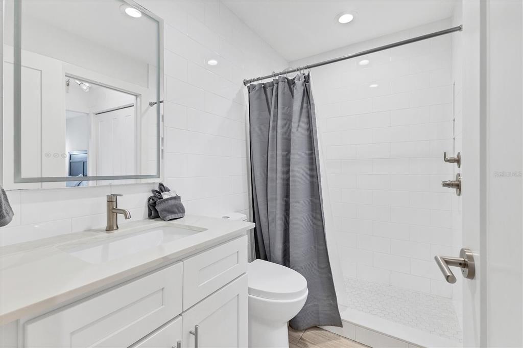 1762 Stickney Point Road, Unit 204 Sarasota, FL 34231 - Photo 24 of 38 a bathroom with a sink toilet and shower