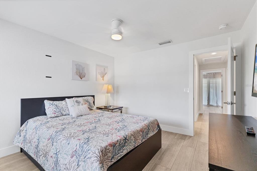 1762 Stickney Point Road, Unit 204 Sarasota, FL 34231 - Photo 27 of 38 a bedroom with a bed and wooden floor