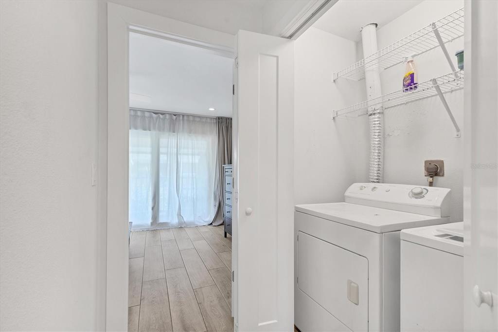 1762 Stickney Point Road, Unit 204 Sarasota, FL 34231 - Photo 28 of 38 a view of storage and utility room with washer and dryer