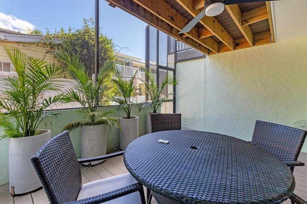 1762 Stickney Point Road, Unit 204 Sarasota, FL 34231 - Photo 30 of 38 a balcony with table and chairs