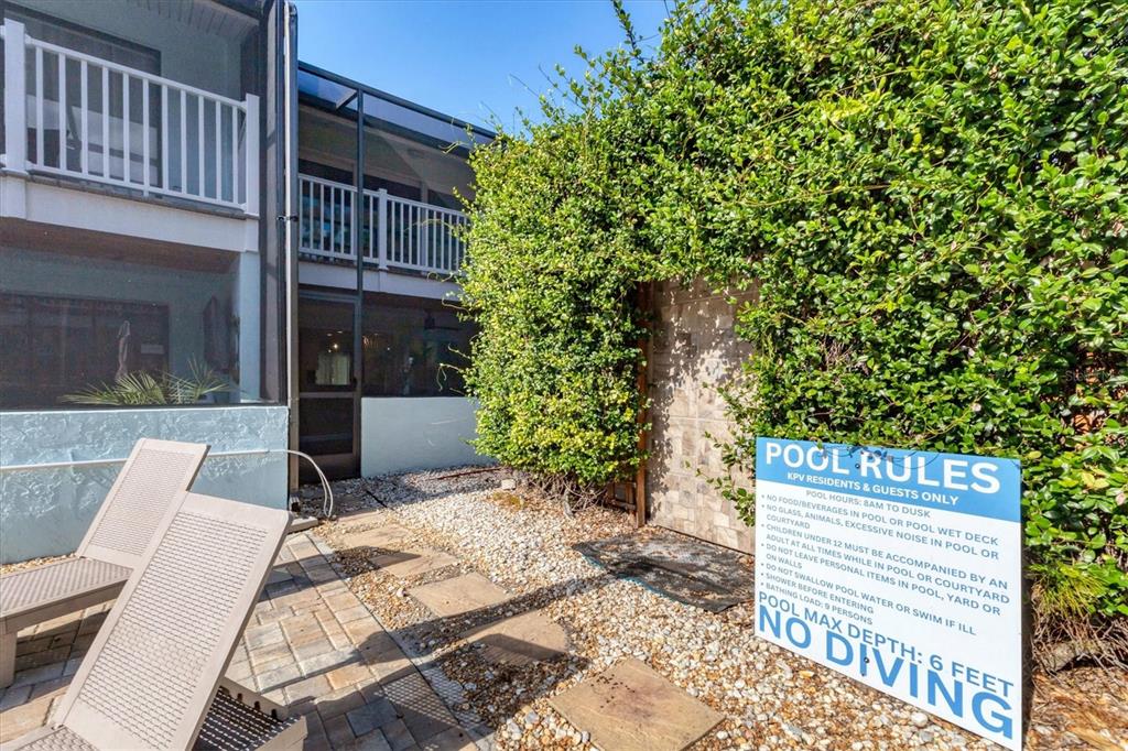 1762 Stickney Point Road, Unit 204 Sarasota, FL 34231 - Photo 32 of 38 a view of a patio with a table and chairs and wooden fence